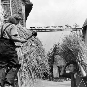 17 year old girl and father rethatch a village. Quite a big job for 17 year old Joyce