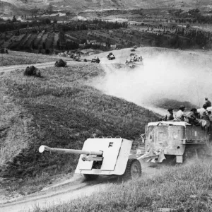 A 17pdr anti-tank gun and half-track of 269 / 87th Anti-Tank Regiment approaches the River