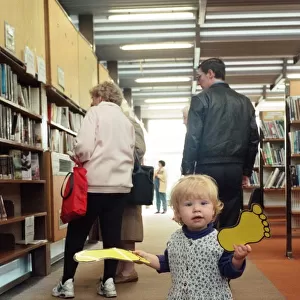 18-month-old Ellen Garbutt of Redcar sorts out the foot prints in Redcar Library