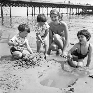 19 year old nanny Birte Anderson on the beach at Bournemouth with children Elizabeth (6)