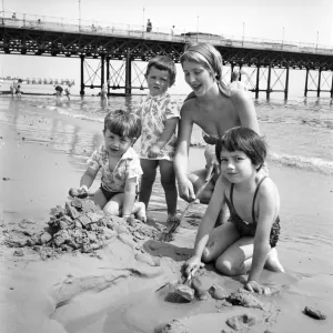 19 year old nanny Birte Anderson on the beach at Bournemouth with children Elizabeth (6)