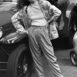 1980s Fashion: Model wears apple green trousers with green white pattern jacket standing 1980s Fashion: Model wears apple green trousers with green white pattern jacket standing