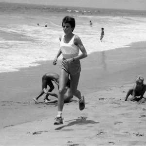 The 1984 Summer Olympics in Los Angeles. Wendy Sly running on Manhattan Beach, California The 1984 Summer Olympics in Los Angeles. Wendy Sly running on Manhattan Beach, California