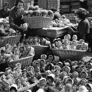 Some of the 2000 dolls that are produced each day in the dressng room. 25th July 1938