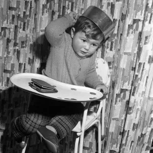 21 month old John Lockey, of Perivale, with the baking tin that he wore as a hat
