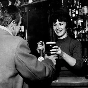 21 year old barmaid Joyce McKnight serving a customer at the Black Bull Pub in Doncaster