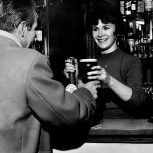 21 year old barmaid Joyce McKnight serving a customer at the Black Bull Pub in Doncaster
