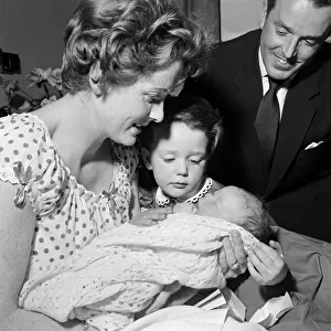 3-year-old Louisa, daughter of Brian Rix and Elspet Gray, meets her new baby brother