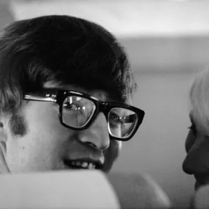 7 February 1964 John Lennon with wife Cynthia on the aircraft to New York 7 February 1964 John Lennon with wife Cynthia on the aircraft to New York