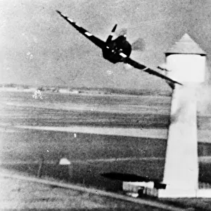 An 8th U. S. A. A. F. P-47 attacks a flak tower at a German aerodrome in occupied France
