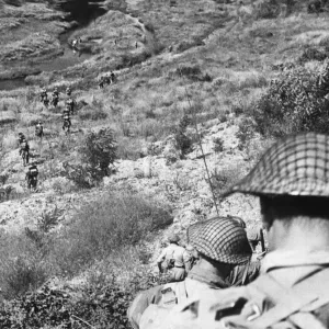 9th Army: Motorised Infantry Patrol in Italy. The men wind their way down into