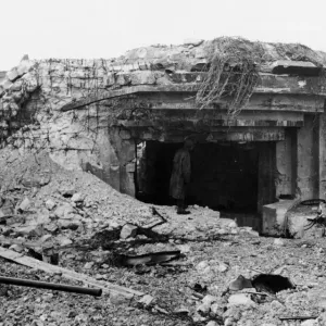 A. G. I peers inquisitively into what remains of former Impregnable Nazi concrete pill box A. G. I peers inquisitively into what remains of former Impregnable Nazi concrete pill box
