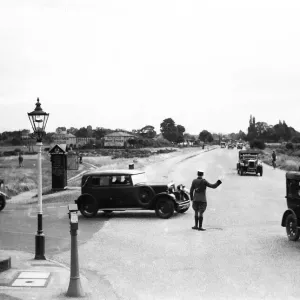 A vintage print of a patrolman directing traffic in Esher A vintage print of a patrolman directing traffic in Esher
