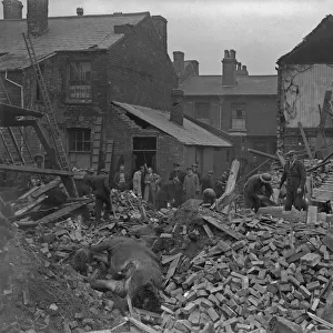 A. R. P workers clearing the debris from a wrecked Smethwick Stables where four horses