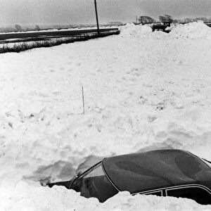Abandoned car lies in the path of the snow clearing machines working between Llantwit