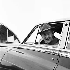 Actor Alec Guinness loading his Bently onto an aircraft bound for France where he will