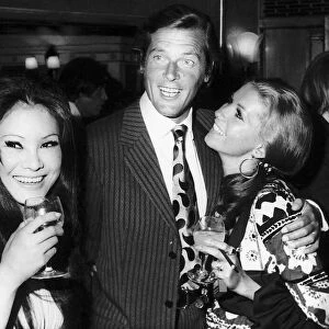 Actor Roger Moore with his Italian wife Louisa - July 1970 And Michael Caine