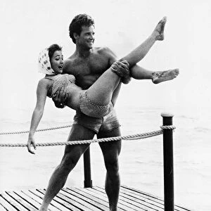 Actor Steve Reeves 1960 standing on a pier by the sea