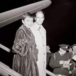 Actress Audrey Hepburn arrives in London Airport with husband December 1954