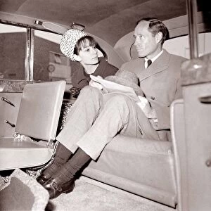 Actress Audrey Hepburn with husband Mel Ferrer in the back seat of a car April 1964