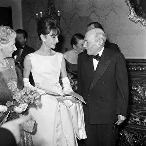 Actress Audrey Hepburn pictured with Earl and Countess Attlee at the London premiere of