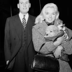 Actress Diana Dors holding her pets as she arrives at court on assault charges