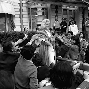 Actress Diana Dors surrounded by autograph hunters at Cannes Film Festival