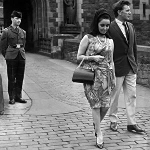 Actress Elizabeth Taylor with her husband Richard Burton walk away disappointed after not