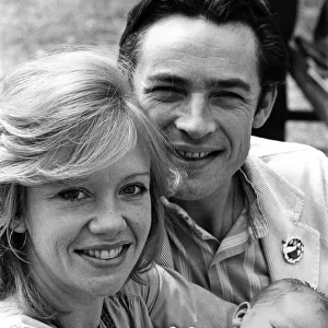 Actress Hayley Mills and actor Leigh Lawson proudly show off their love child for