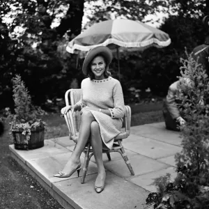 Actress Honor Blackman relaxes in her garden party outfit during the filming of Actress Honor Blackman relaxes in her garden party outfit during the filming of
