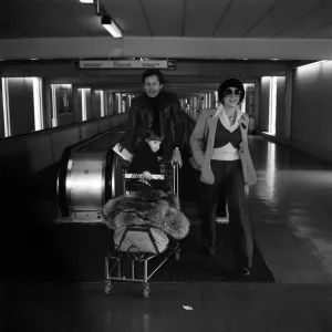 Joan Collins and Family at Heathrow, 1975 Print