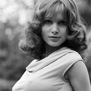 Actress Madeline Smith poses outdoors wearing sleeveless top. 12th September 1976