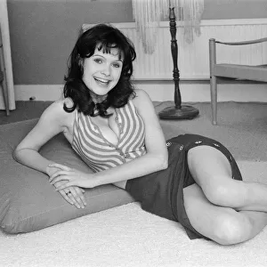 Actress Madeline Smith watching television at her flat in Kew. 6th September 1974