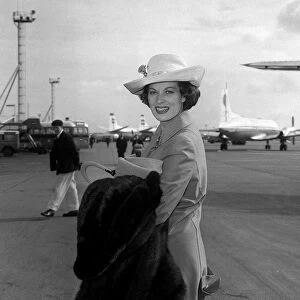 Actress Maureen O Hara arrives at London Airport on her way to Milan for costume