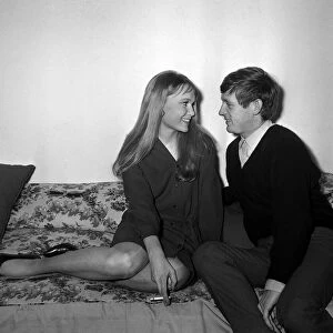 Actress Mia Farrow with singer John Leyton April 1964 sitting on sofa talking