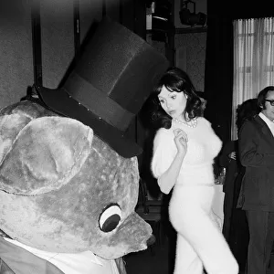 Actress and former model Madeline Smith picture with a giant teddy bear at a Variety Club