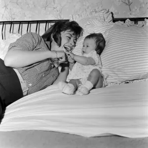 Actress Nanette Newman with her baby daughter Sarah Kate at their home in Virginia Water