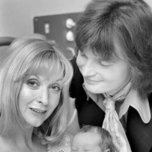 Actress: Nyree Dawn Porter with husband and baby. January 1975