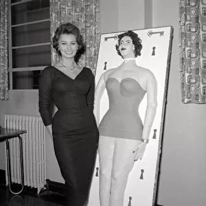 Actress Sophie Loren seen here standing beside a life size cake of her self Circa