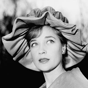 Actress Sylvia Syms wearing fancy hat