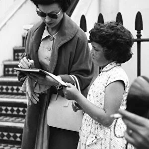 Actress Vivien Leigh signing autographs for a young fan in London August 1956