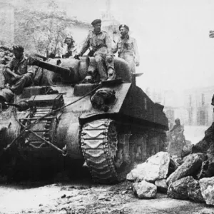 Print of a Sherman tank passing through a road barrier in Nicastro, Italy
