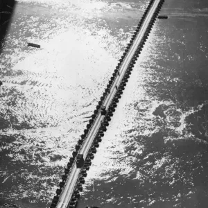 Aerial view of the 1st US Army Trucks and equipment rolling across a pontoon bridge over Aerial view of the 1st US Army Trucks and equipment rolling across a pontoon bridge over