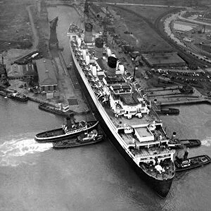 An aerial view of the liner Queen Mary leaving dry dock at Southampton