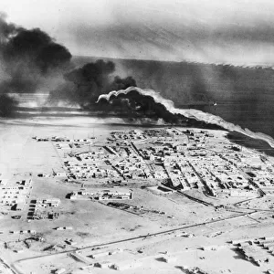 Aerial view of Tobruk with petrol burning. The cruiser San Giorgio