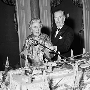 Agatha Christie cuts cake with sword 1962 at 10th anniversary of the play Mousetrap