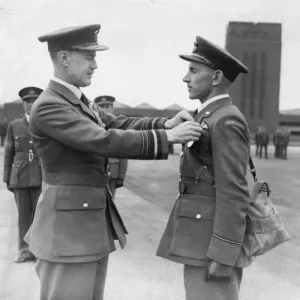 Air Office Commander JT Babington presents The Air Force Medal to Pilot Officer Hrncir Air Office Commander JT Babington presents The Air Force Medal to Pilot Officer Hrncir