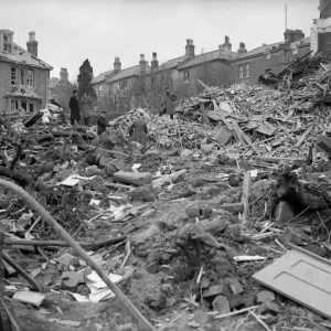 Air raid damage in Coventry Civilians search the rubble of thier bomb damaged