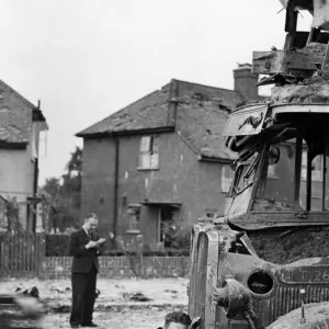 Air Raid damage during the Second World War, a man looking at damage to a bus Air Raid damage during the Second World War, a man looking at damage to a bus
