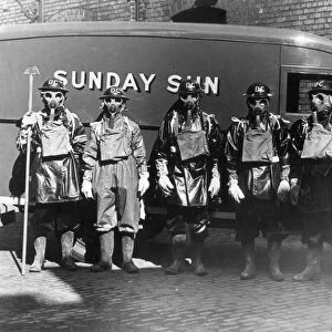 Air raid precautions - Men wearing World War Two gas masks and protective clothing